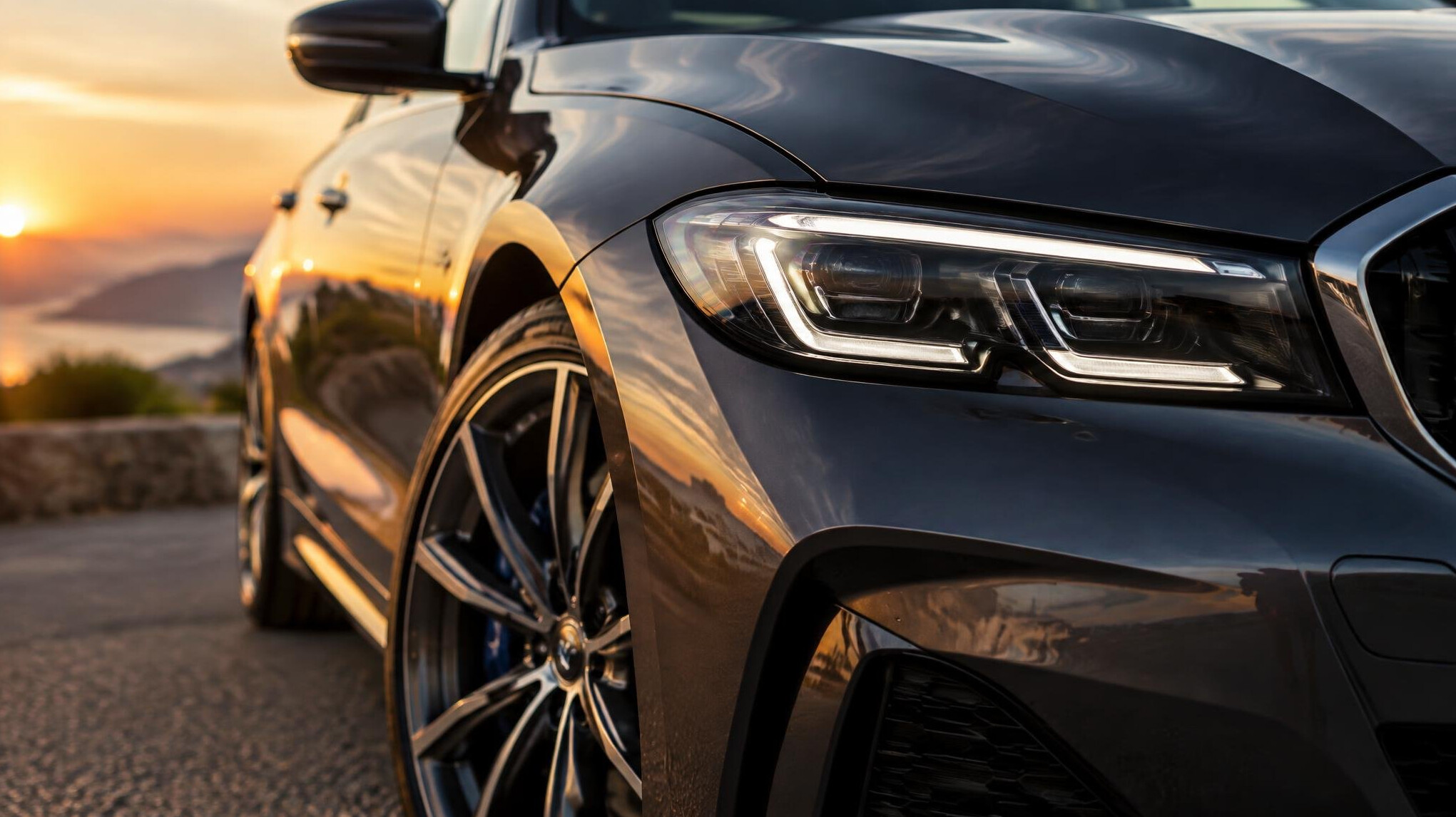 Close-up of a car body and wheel in warm light