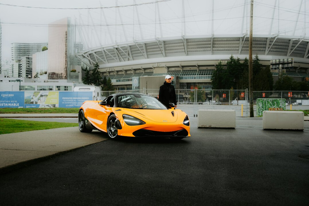 Orange hypercar parked in a modern setting